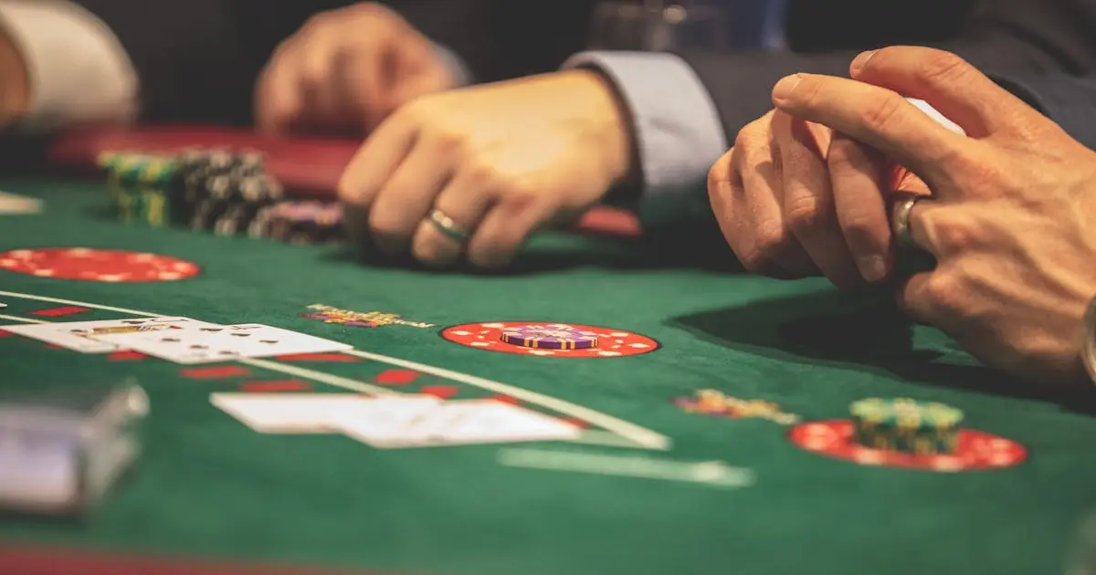 Gold casino chips and playing cards next to slot machine reel symbolising the highest RTP slot rankings